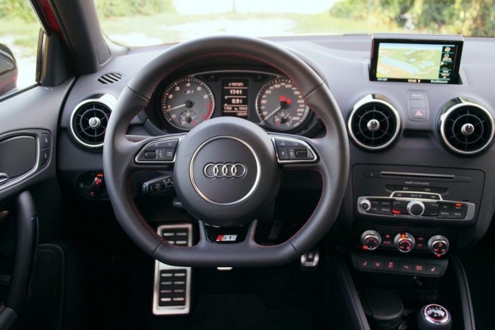 Lapított kormány, fémberakásos pedálok és sok vörös cérna adja meg a hangulatot