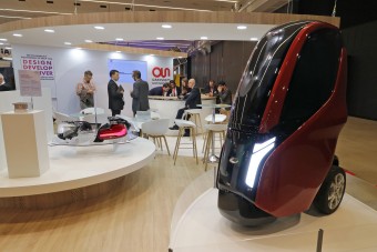 Egyszemélyes törpeautó, amiben állva lehet utazni a járdán