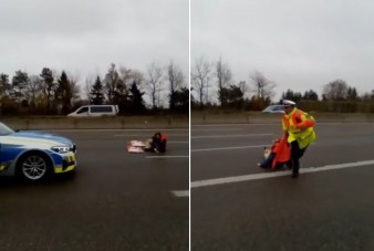 Fél kézzel tette helyre a rendőr az autópályára fekvő aktivistát
