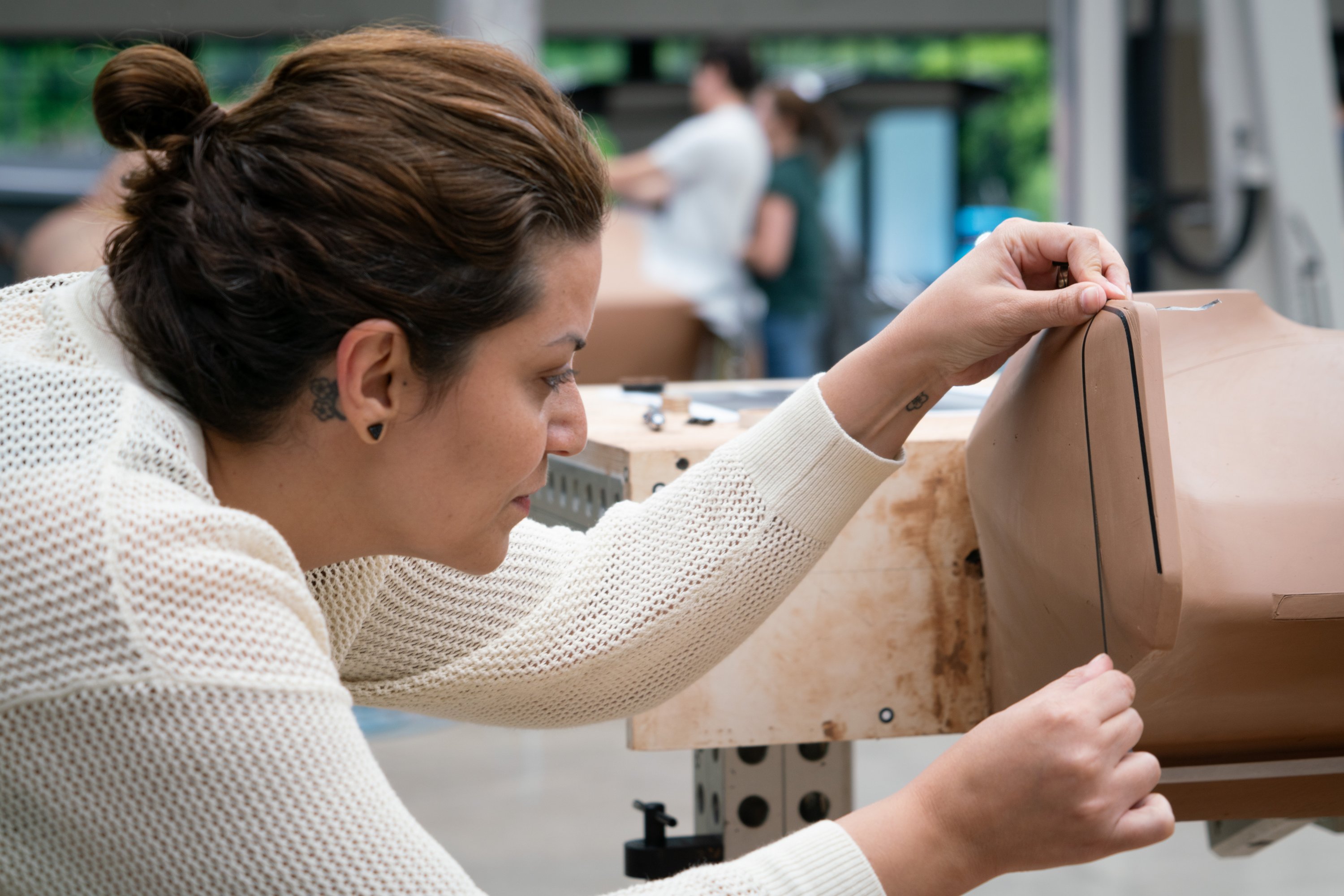 general_motors_advanced_design_pasadena_creative_designer_junia_lapp_working_on_clay_mode | Vezess | Vezess