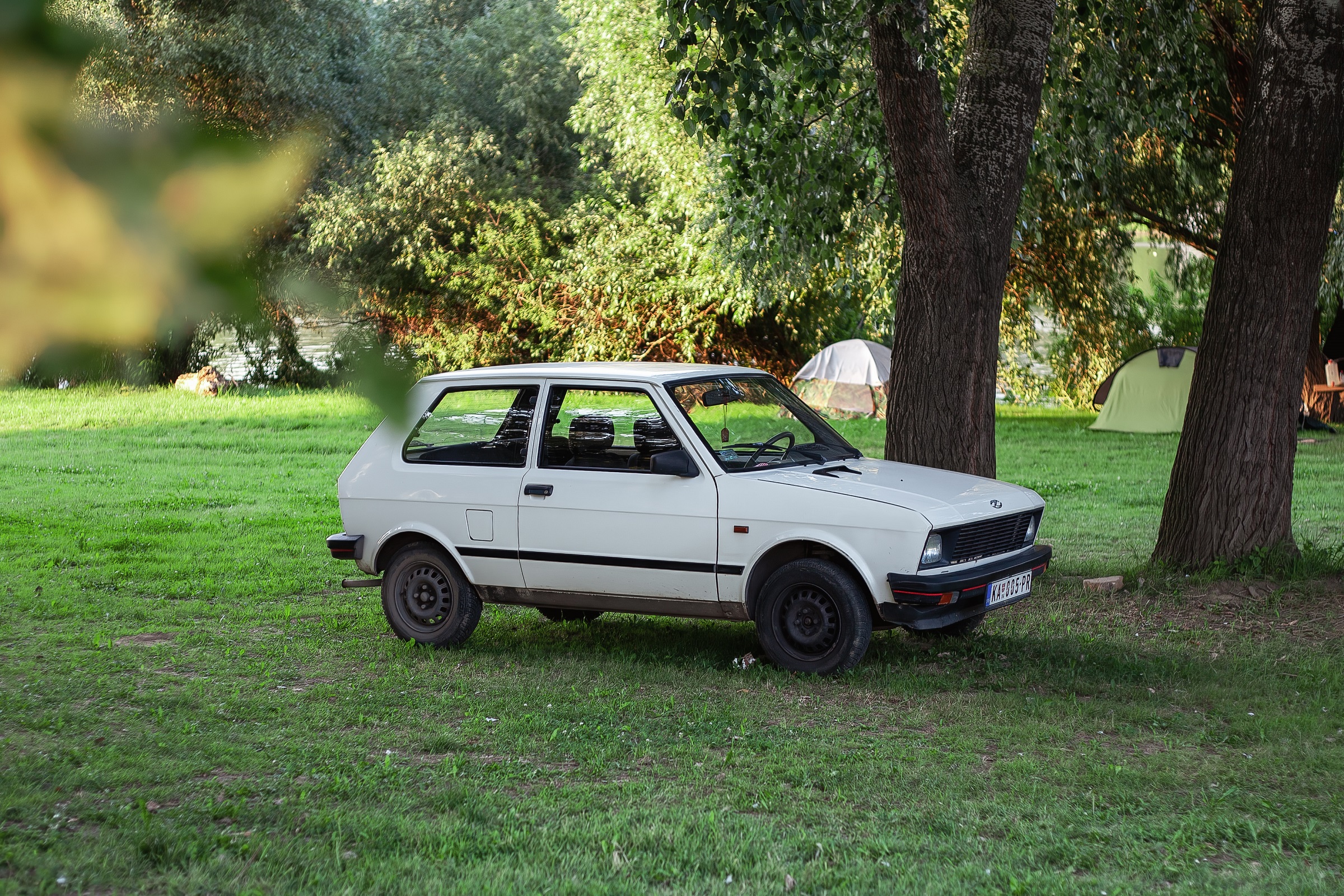 Late Zastava Koral YUGO Koral Yugo Tempo in white color is parked Kanjiza kamping Serbia 22082023 | Vezess