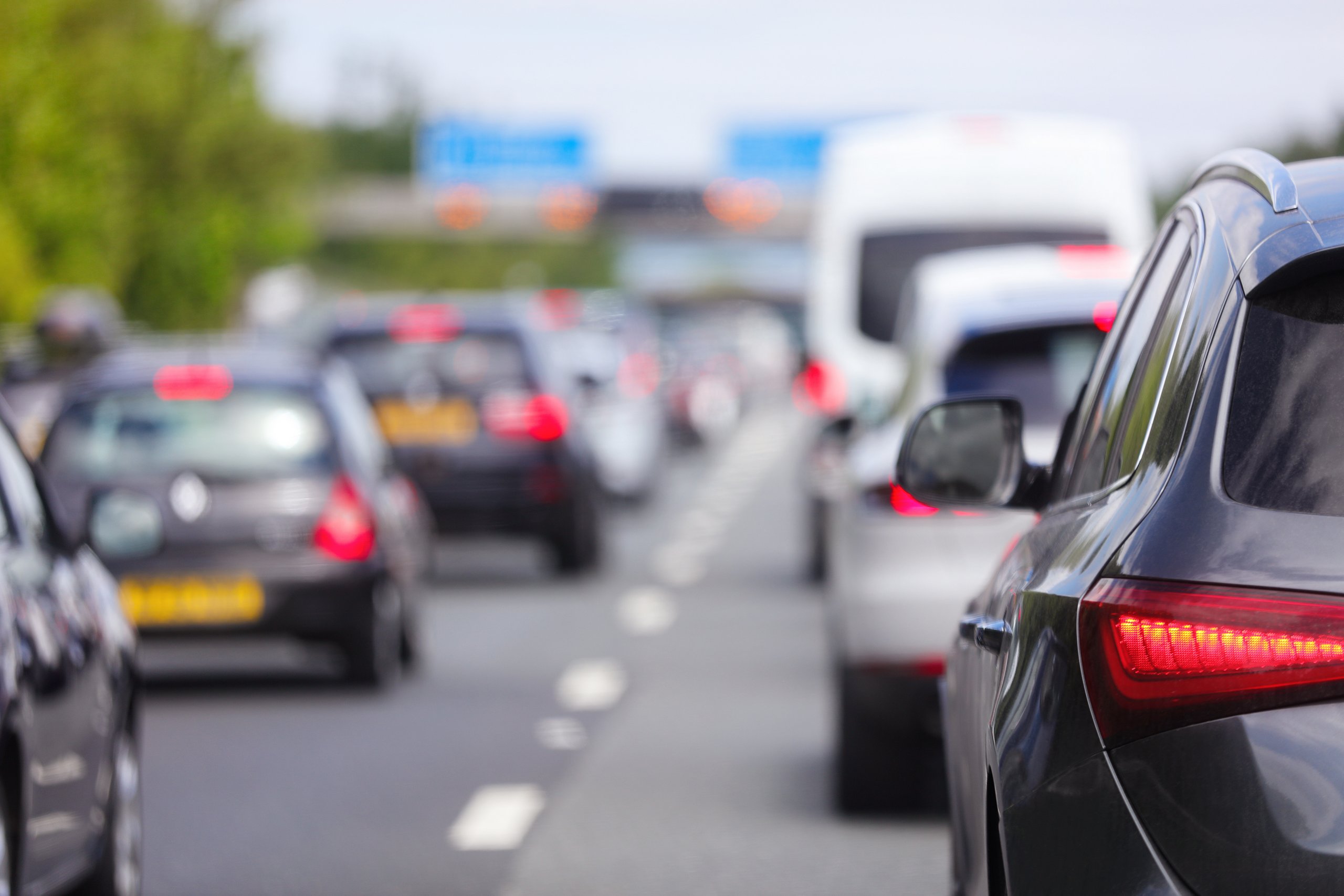 Traffic jam congestion with rows of cars on highway or motorway | Vezess